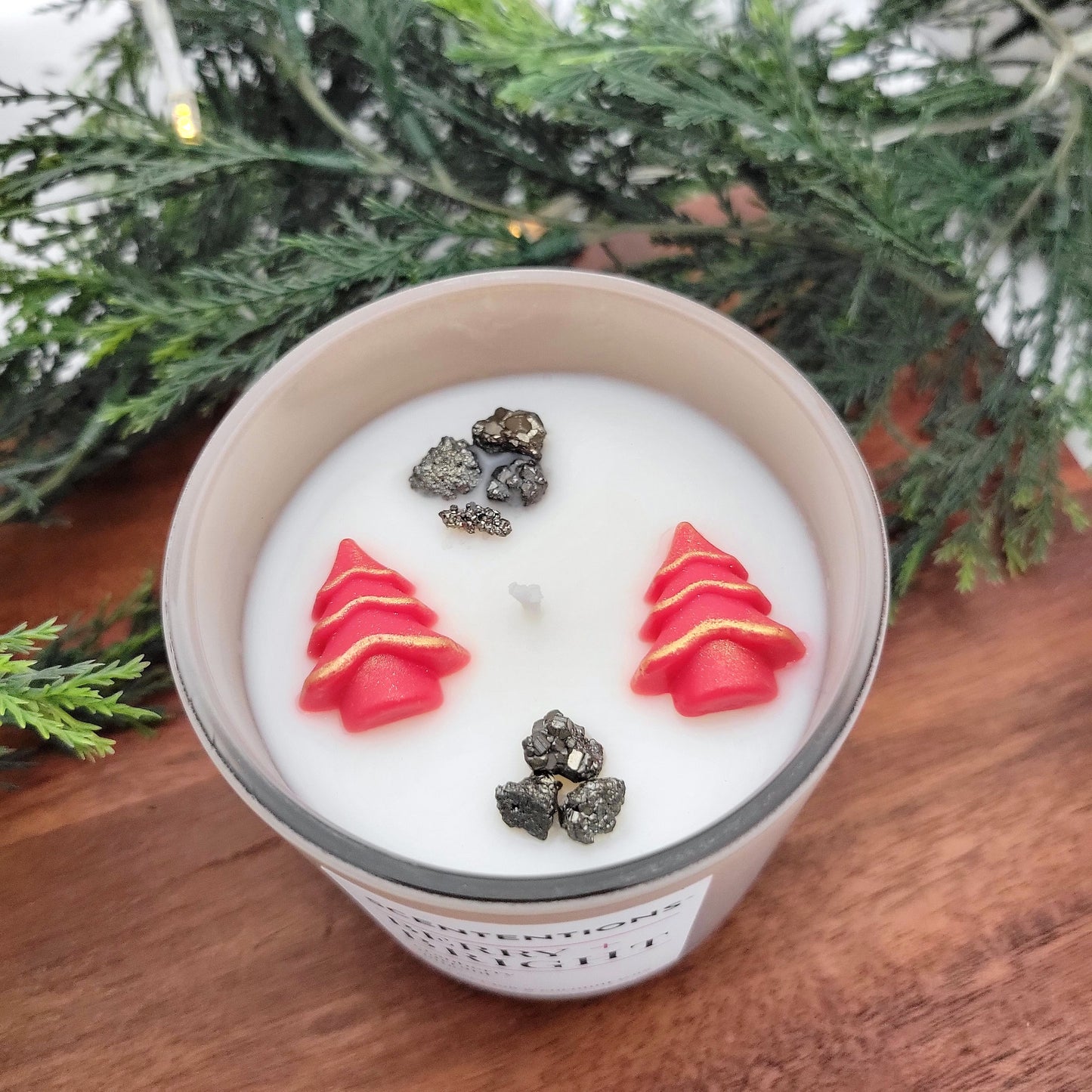 Overhead view of Berry + Bright holiday candle showing festive wax embeds and pyrite crystals in coconut wax.