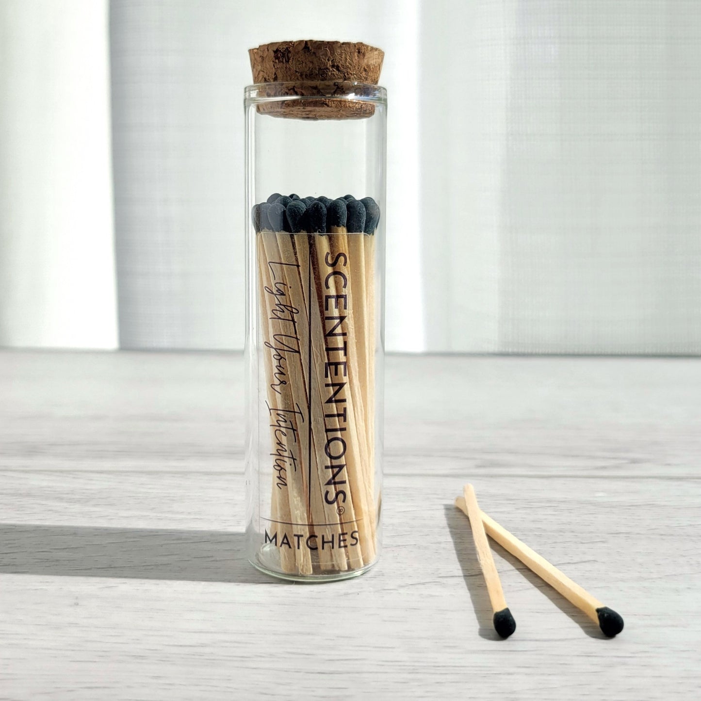 Black tip matches in glass jar with cork lid