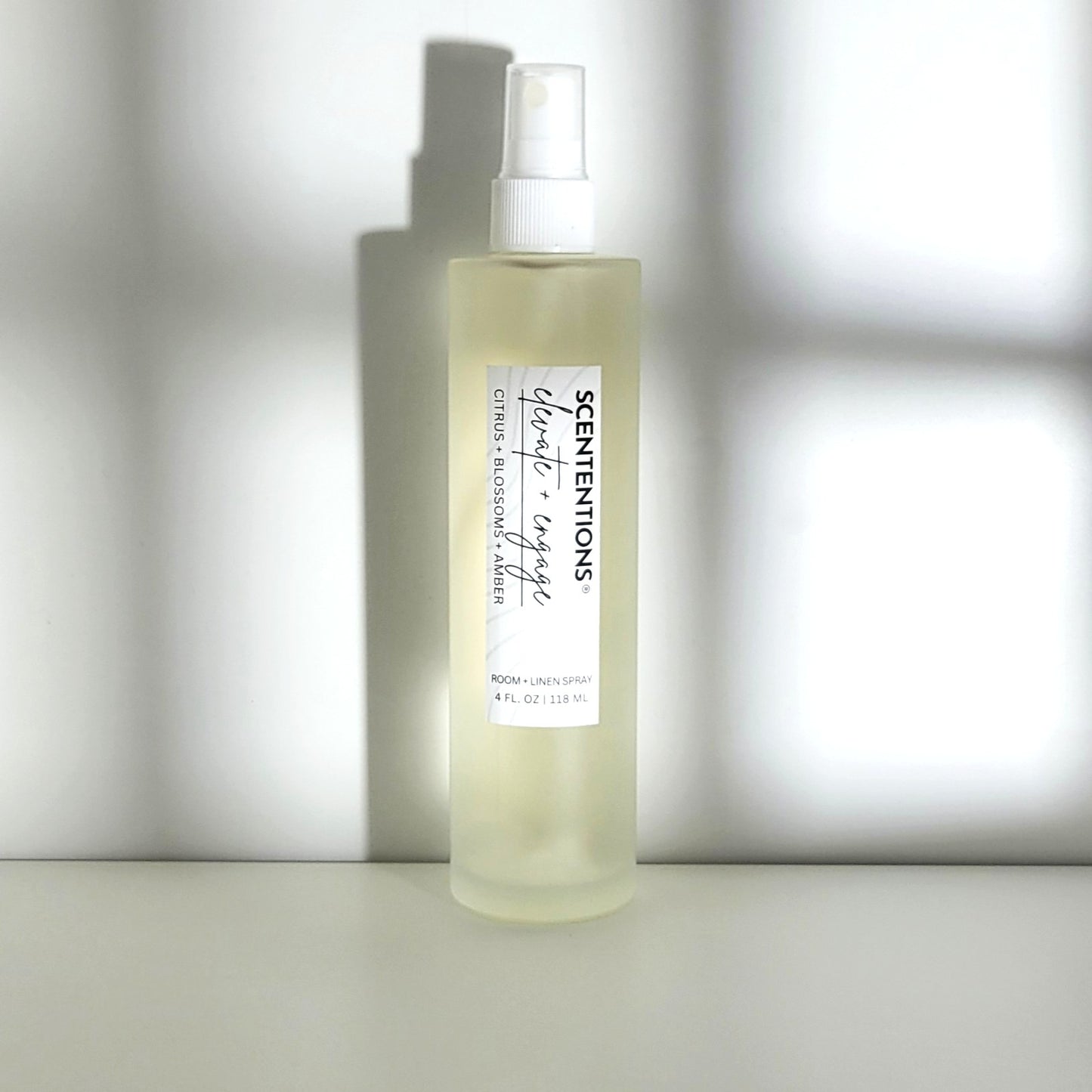 Elevate + Engage room spray with citrus, blossom, and amber notes, designed for uplifting energy in modern setting