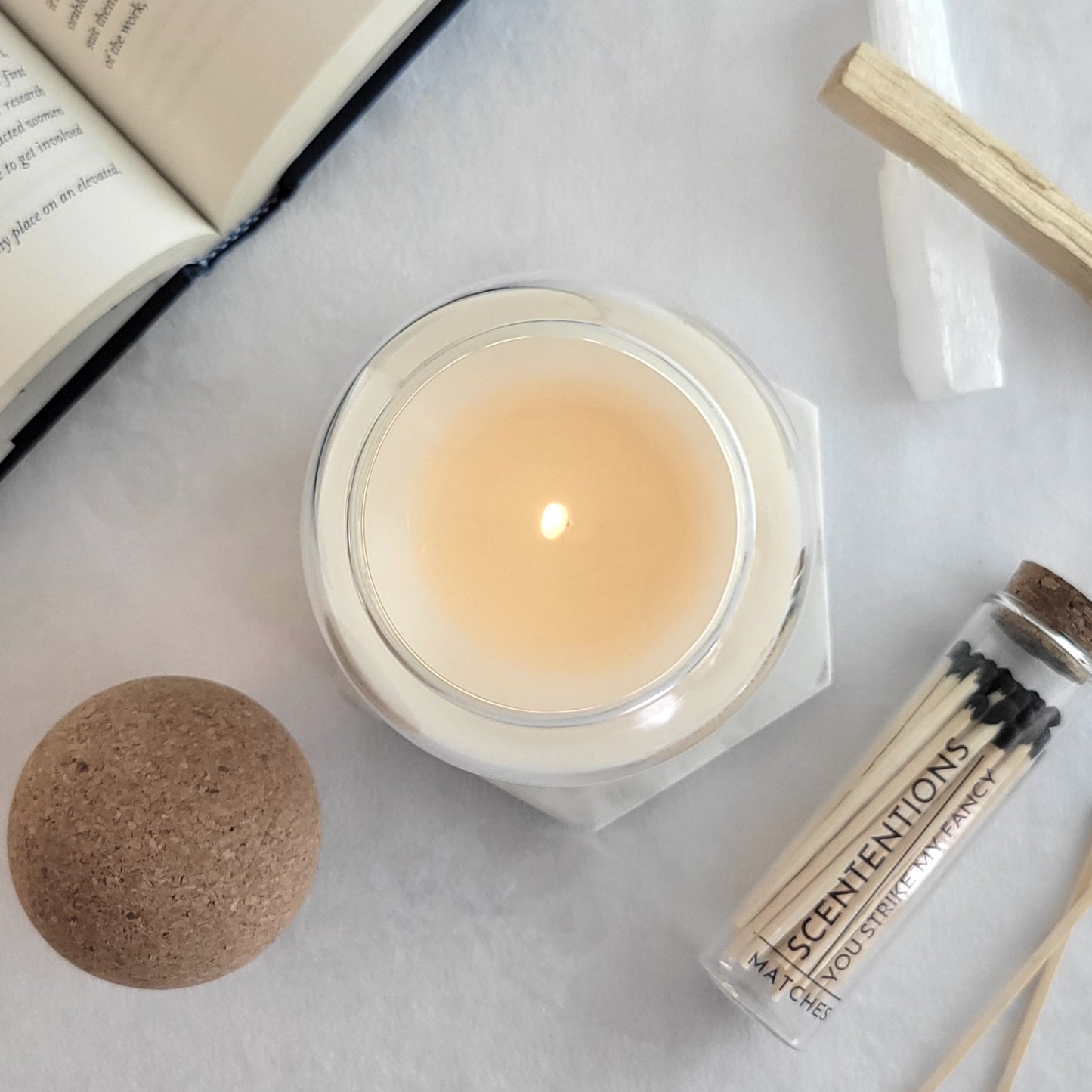 Aesthetic candle flatlay with matches and book – organic coconut wax by Scententions