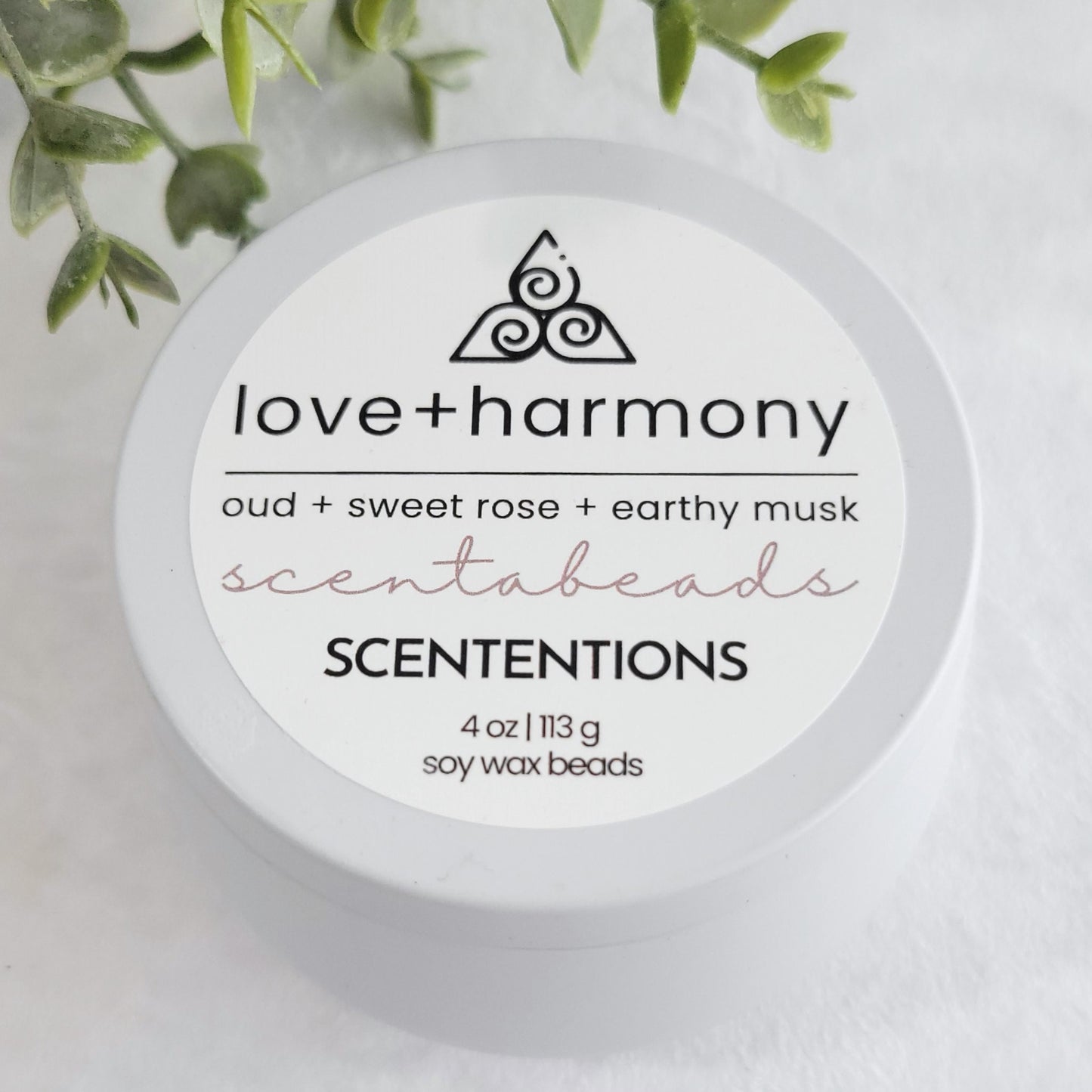 Love + Harmony wax melt beads with Oud, Sweet Rose & Earthy Musk in eco-friendly packaging by scententions