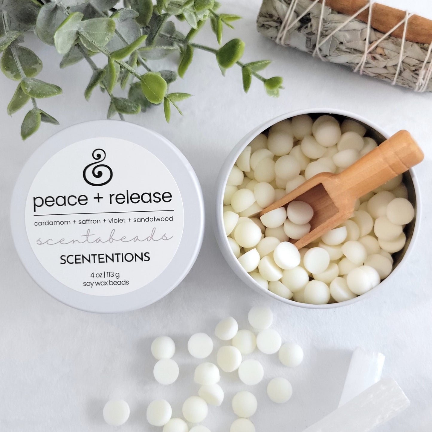 Peace + Release wax melt beads in tin container with reusable wooden scoop
