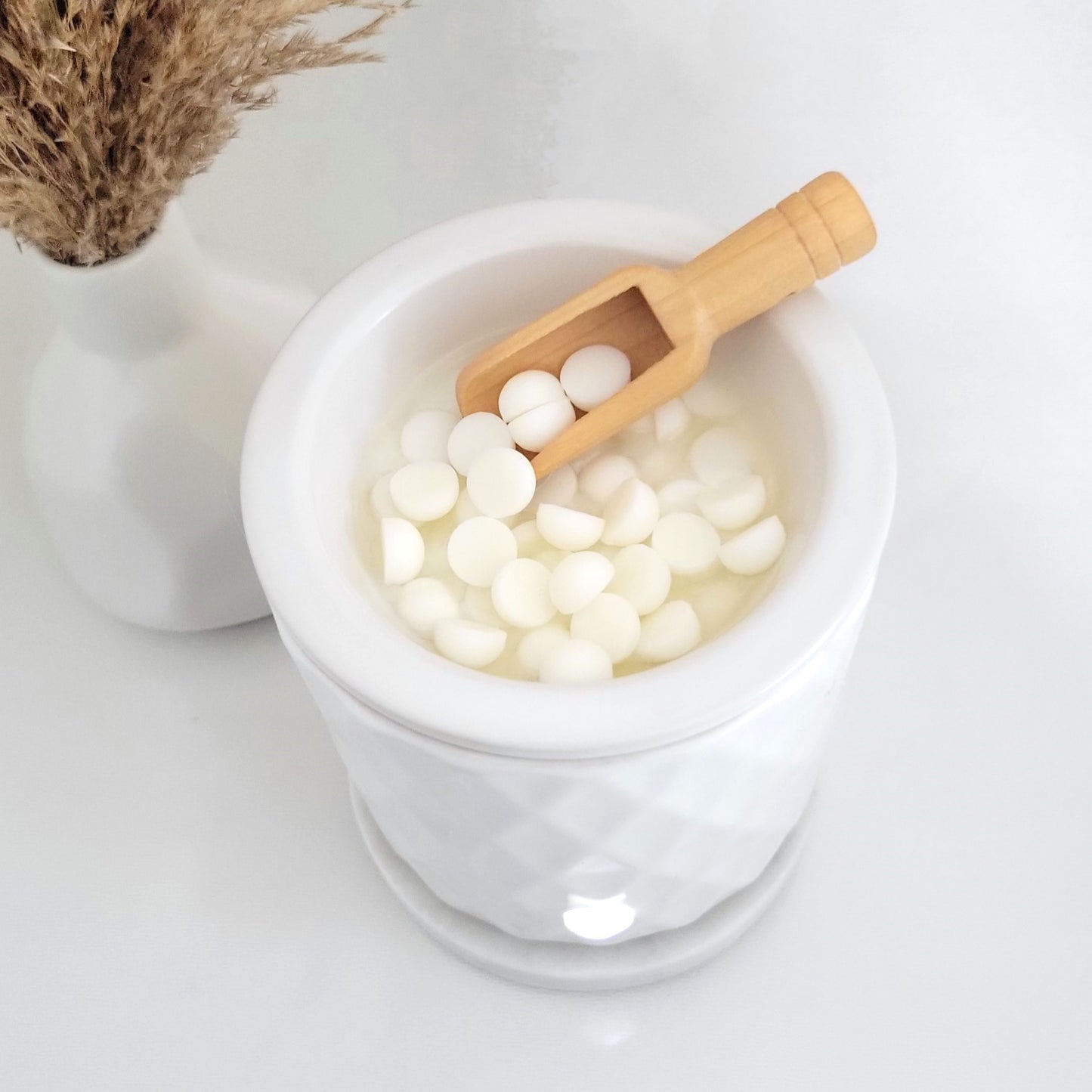 Soy wax melt beads melting in electric wax warmer for flameless aromatherapy ritual