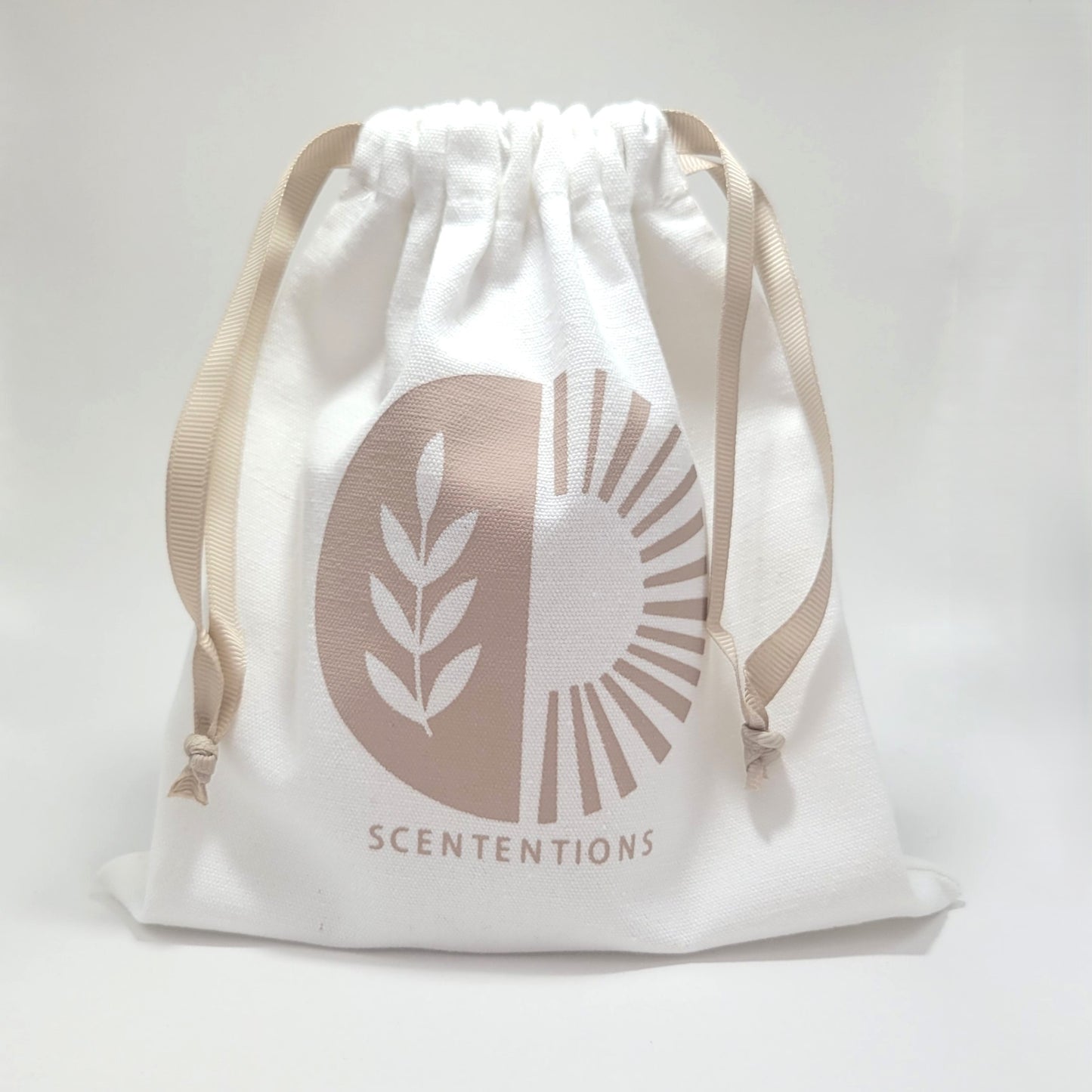 Reusable canvas drawstring tote included with Scententions Wanderlust crystal coconut wax candle.