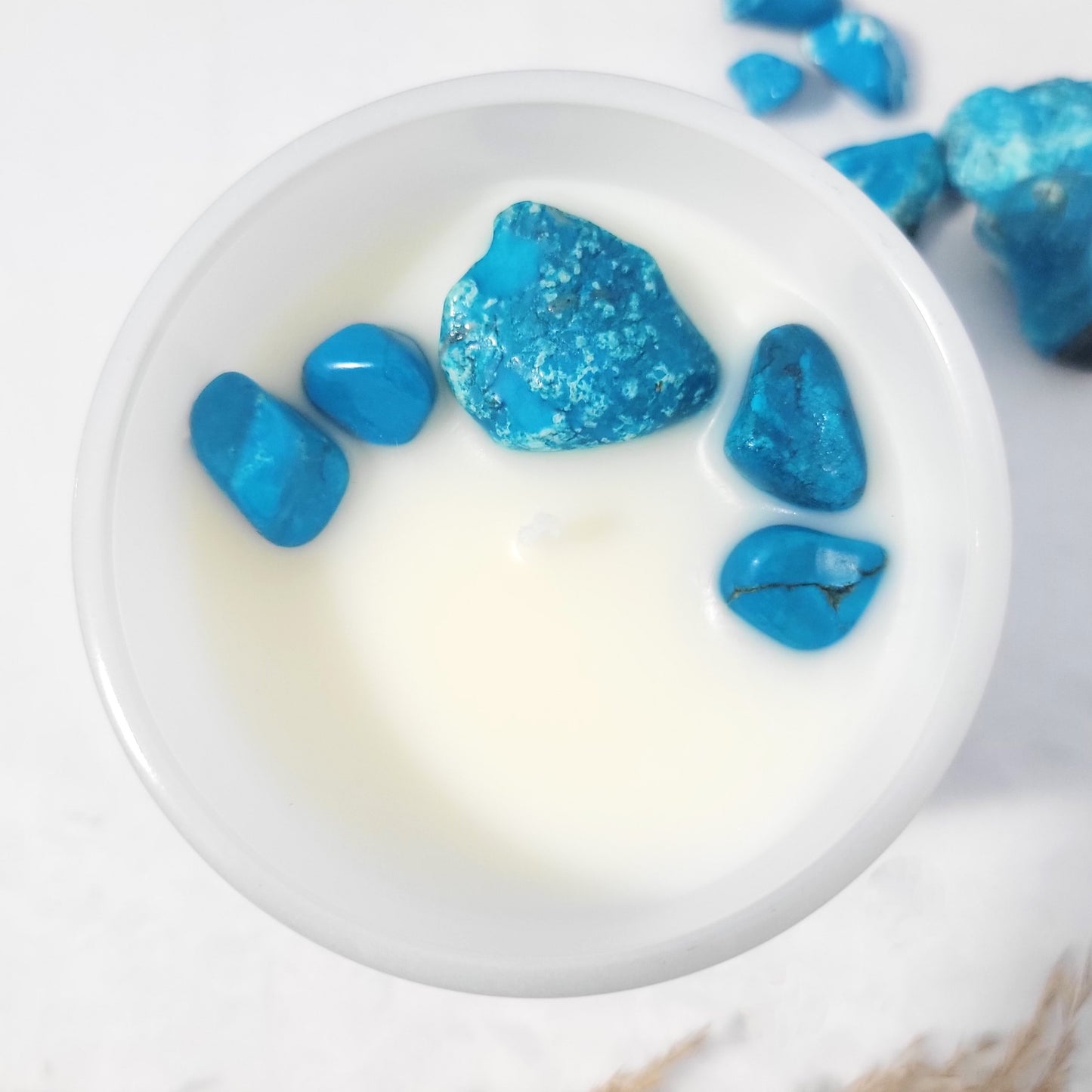 Top view of Voyage + Vibes candle showing embedded turquoise howlite crystal in organic coconut wax