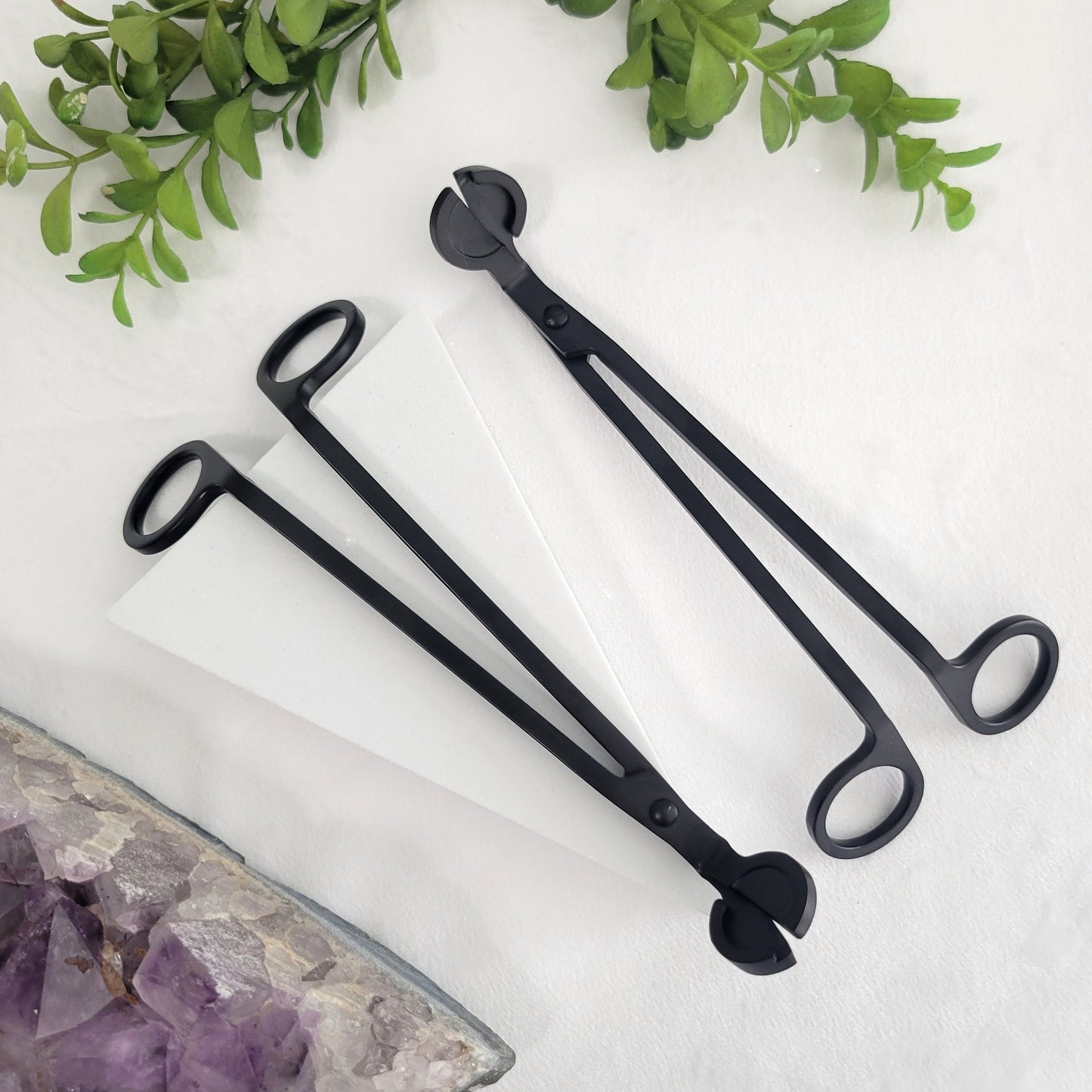 Matte black wick cutter styled as a decorative candle accessory. Sleek design pairs perfectly with intentional candle rituals.