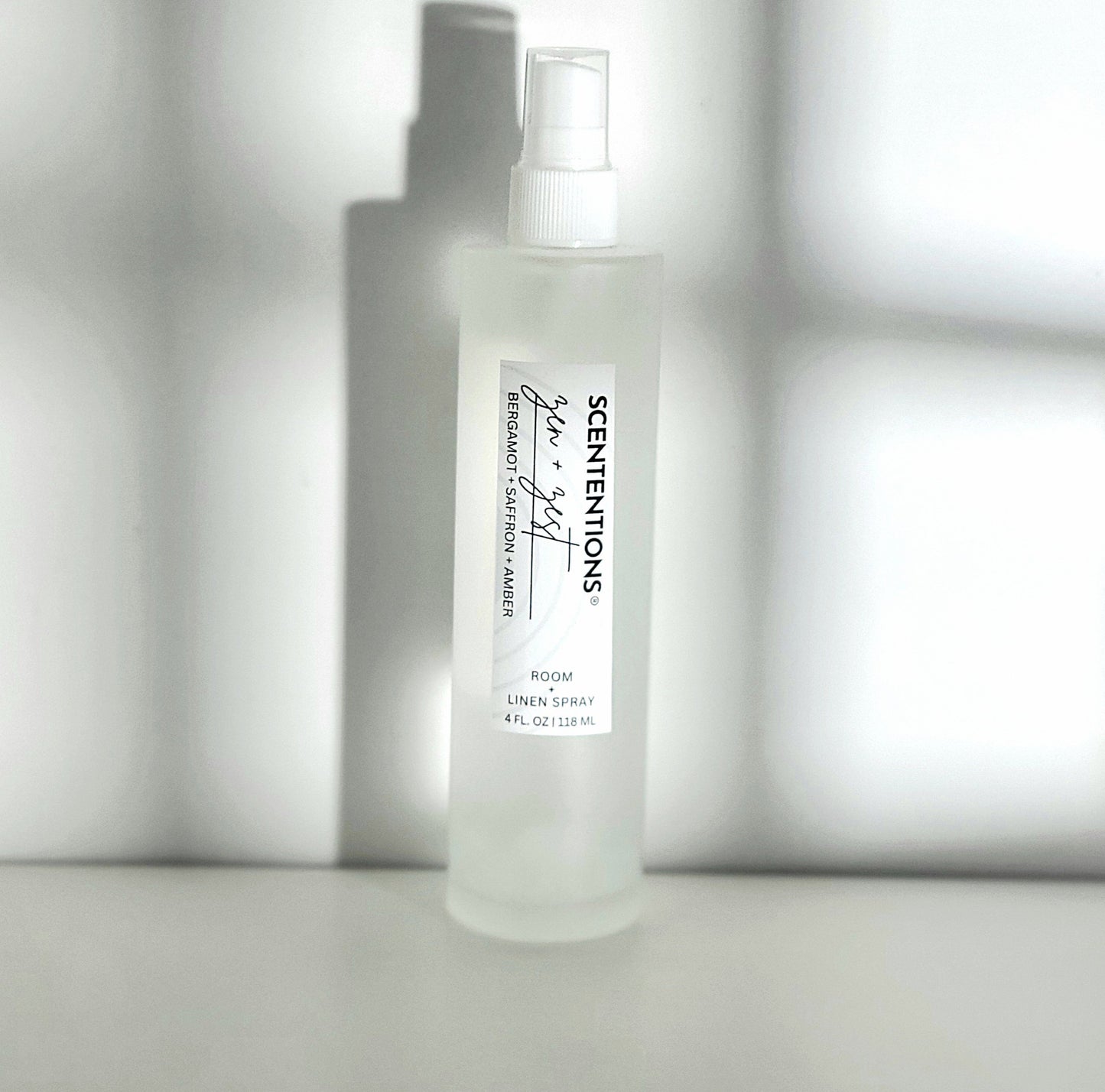 Zen + Zest room spray with notes of bergamot, saffron, and amber for calm and clarity in modern setting