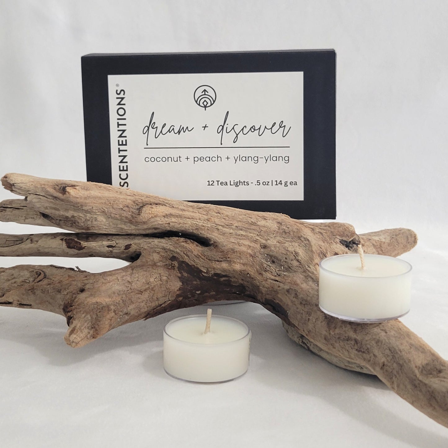 Dream + Discover tea light candle set with packaging on a neutral background.