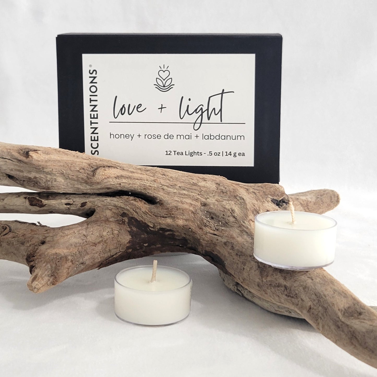 Love + Light tea light candle set with packaging on a neutral background.