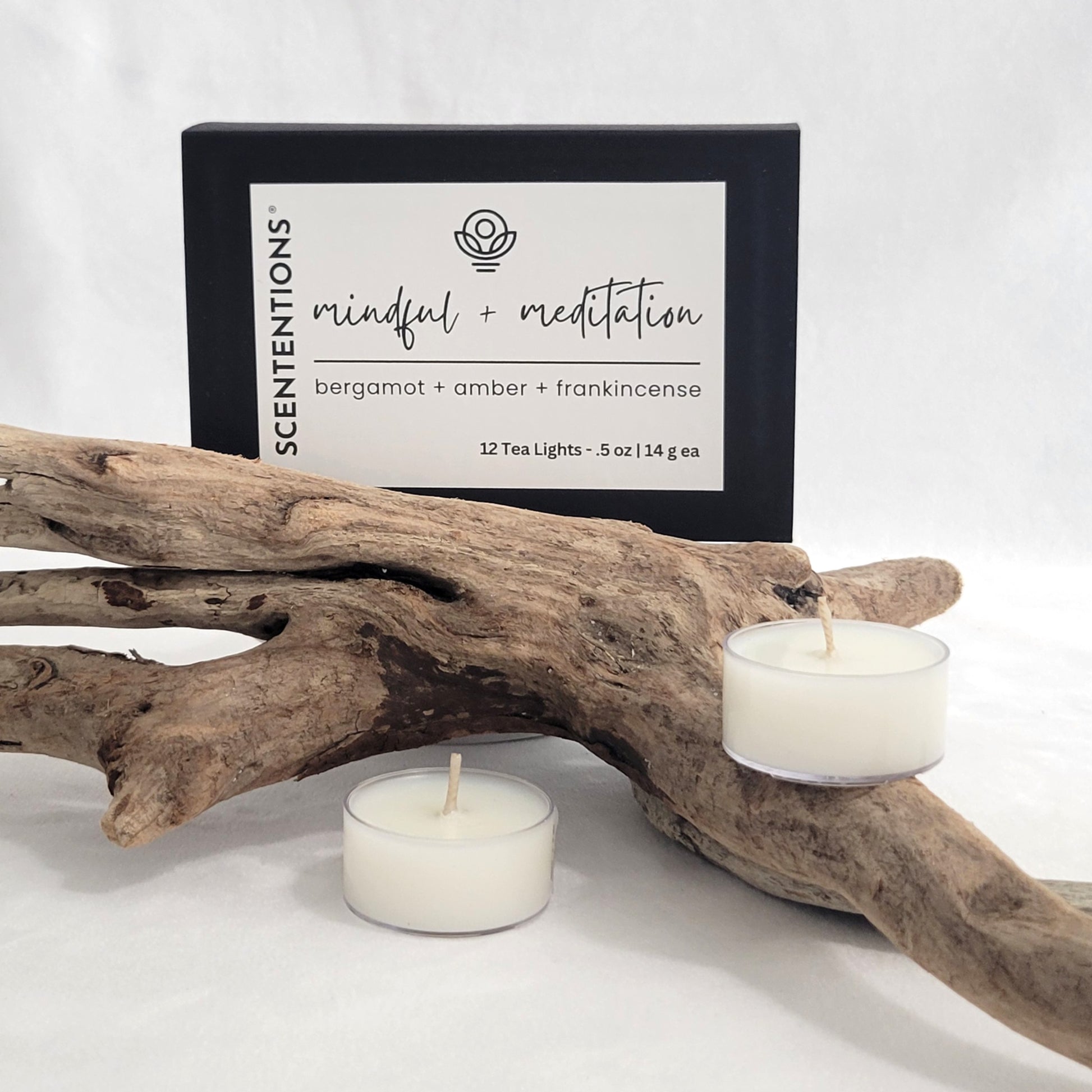 Mindful + Meditation tea light candle set with packaging on a neutral background.