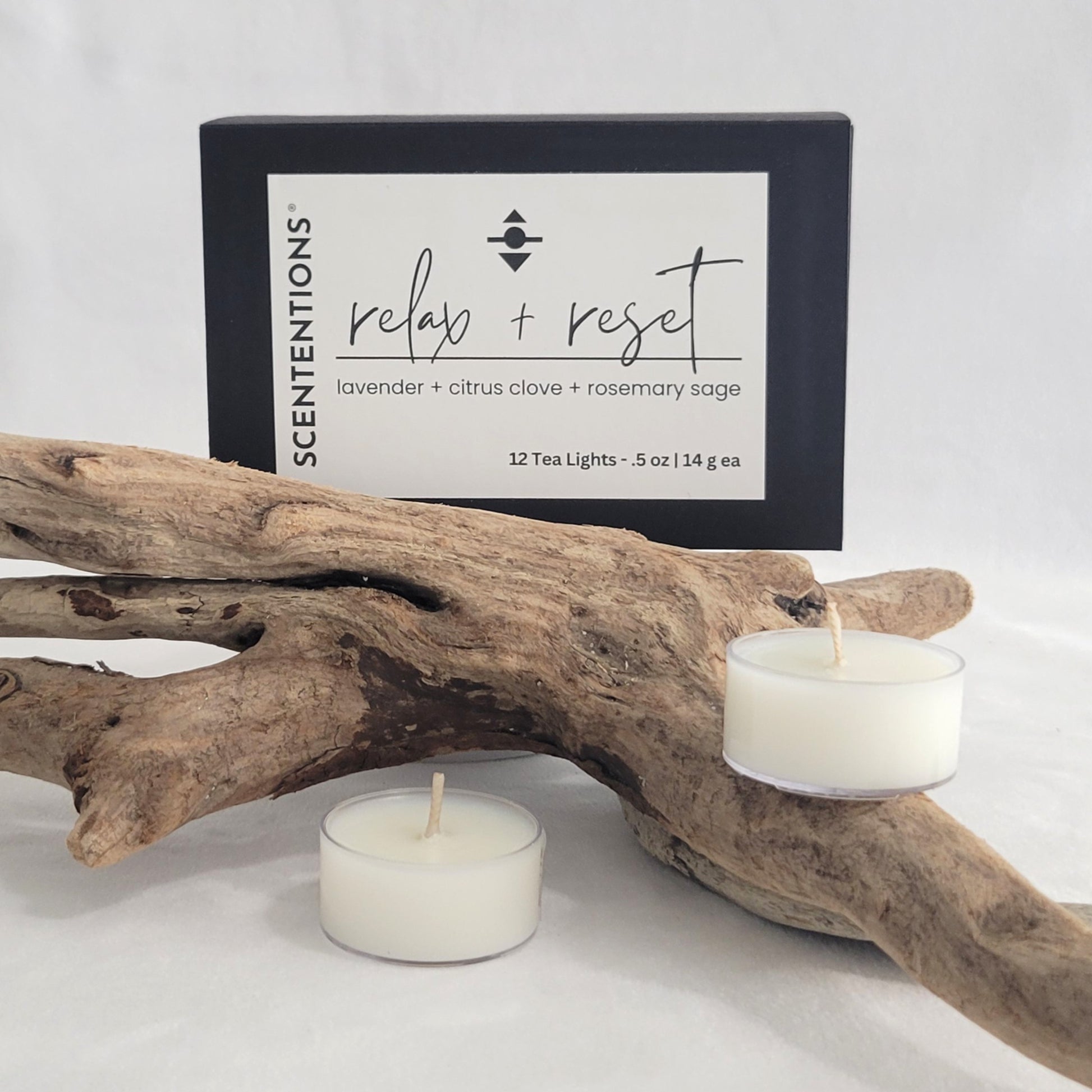 Relax + Reset tea light candle set with packaging on a neutral background.