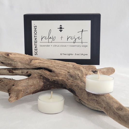 Relax + Reset tea light candle set with packaging on a neutral background.