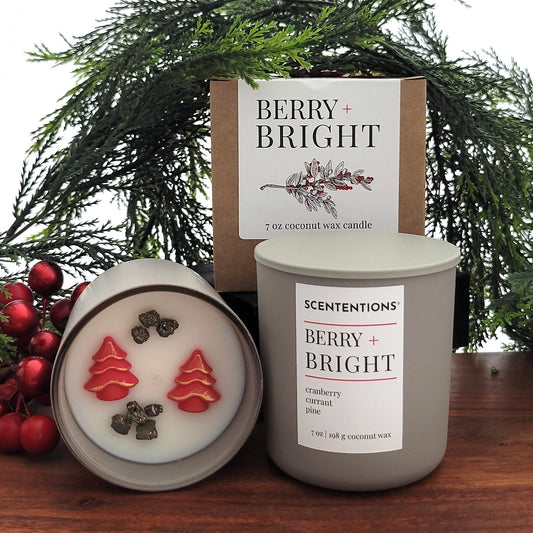 Berry + Bright holiday candle with cranberry, currant, and pine. Shown with vessel, box, and candle top featuring wax embeds and pyrite crystals.