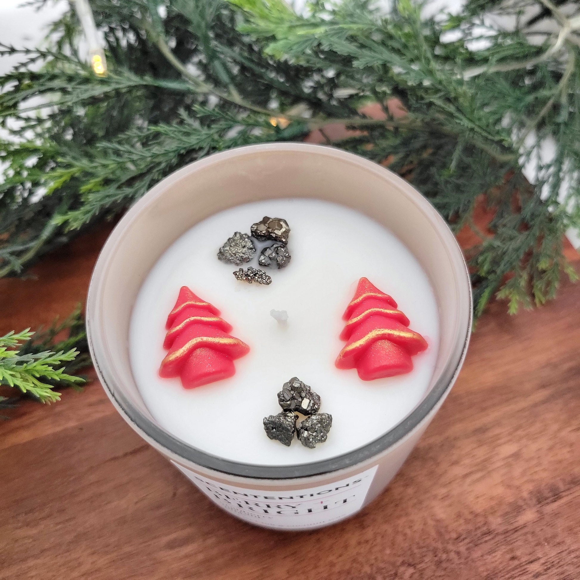 Overhead view of Berry + Bright holiday candle showing festive wax embeds and pyrite crystals in coconut wax.