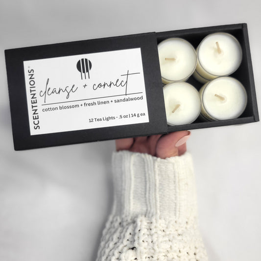 Cleanse + Connect Tea Light Set with cotton blossom and sandalwood scent in a serene setting by Scententions