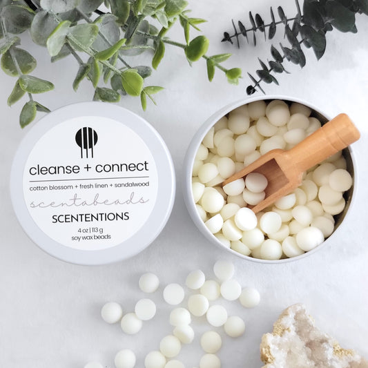 Cleanse + Connect wax melt beads in tin container with reusable wooden scoop