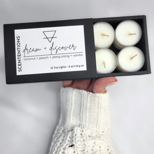 Dream + Discover tea light set with coconut, peach, and ylang-ylang scent held in hand by Scententions