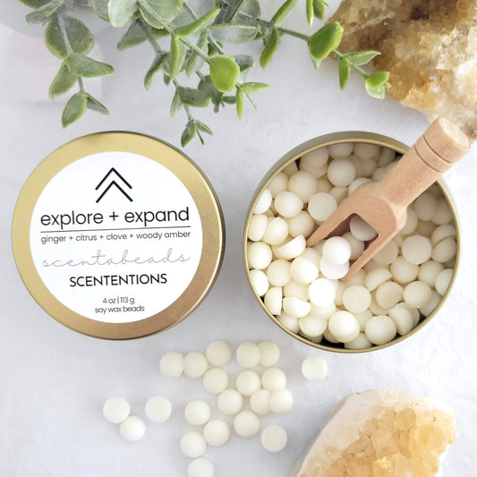 Explore + Expand soy wax melt beads with Citrus, Ginger, and Amber Cedar for energizing and adventurous aromatherapy by Scententions.
