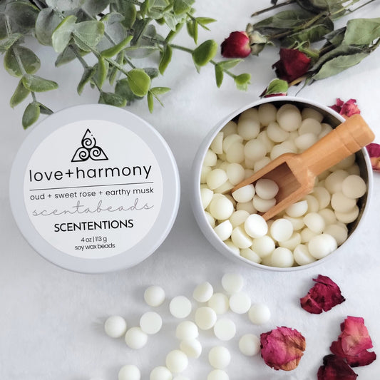 Love + Harmony wax melt beads in tin container with reusable wooden scoop by scententions