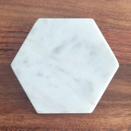 Close-up of hexagon marble candle coaster with clean edges and natural stone texture