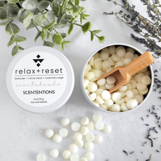Relax + Reset wax melt beads in eco-friendly tin with soothing scent blend and scoop