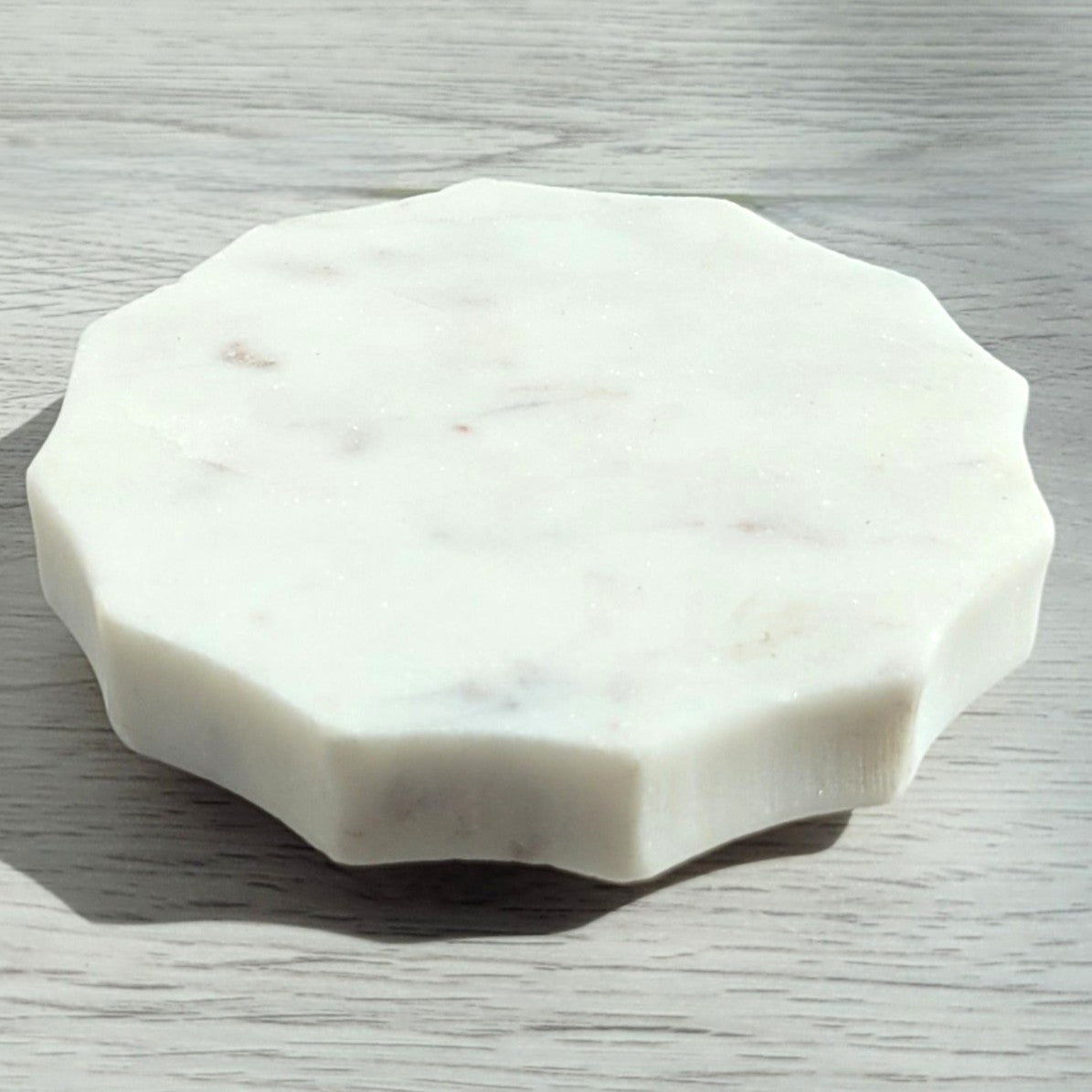 Scalloped white marble candle coaster