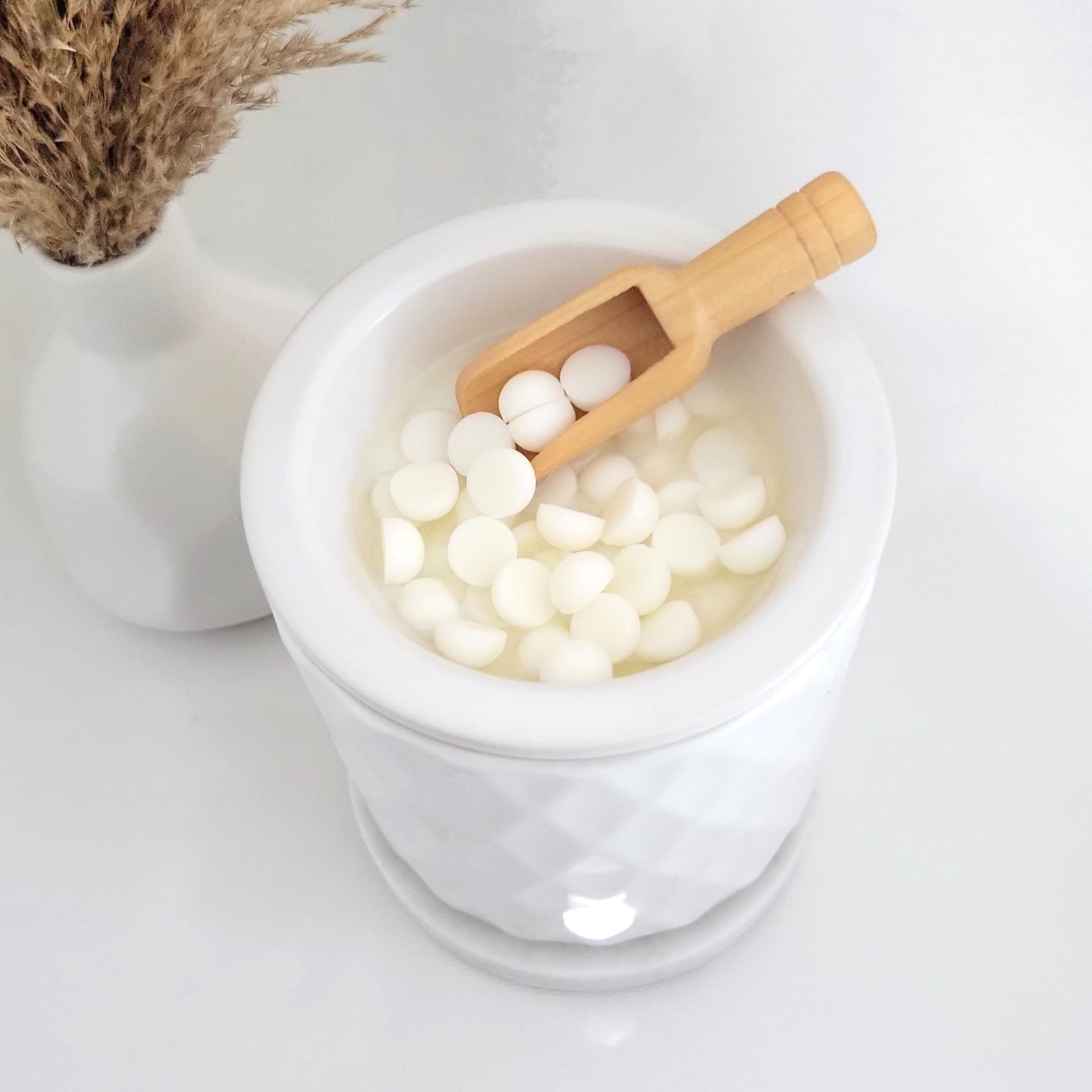 Soy wax melt beads melting in electric wax warmer for flameless aromatherapy ritual