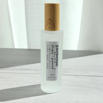 Scententions Bright + Balanced room and linen spray, frosted glass bottle with wood cap.