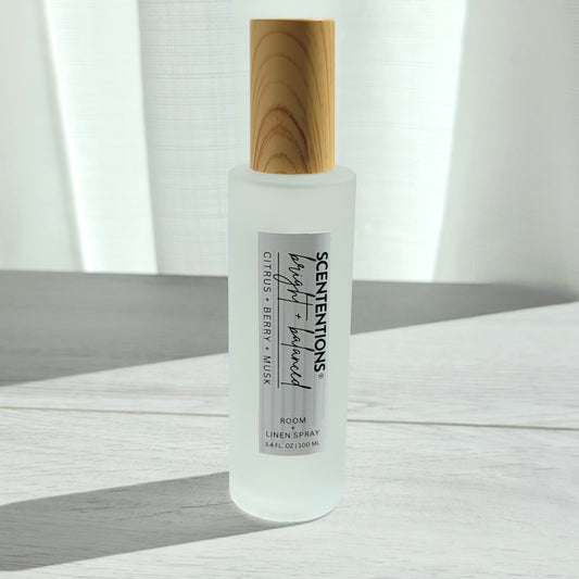 Scententions Bright + Balanced room and linen spray, frosted glass bottle with wood cap.