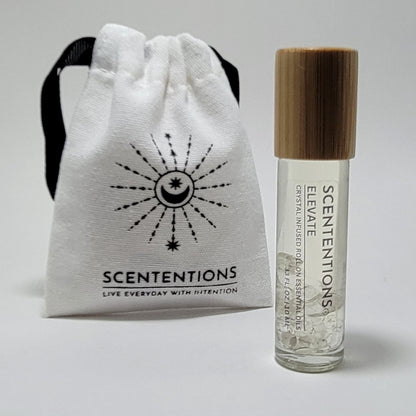 Crystal infused roll-on essential oil with Clear Quartz crystals next to Scententions canvas pouch