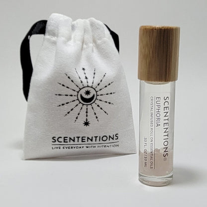 Crystal infused roll-on essential oil with Rose Quartz crystals next to Scententions canvas pouch