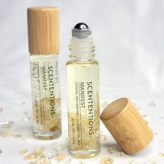 Manifest crystal infused essential oil roll-on with bergamot, cinnamon, and lavender scent