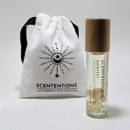 Crystal infused roll-on essential oil with Citrine crystals next to Scententions canvas pouch