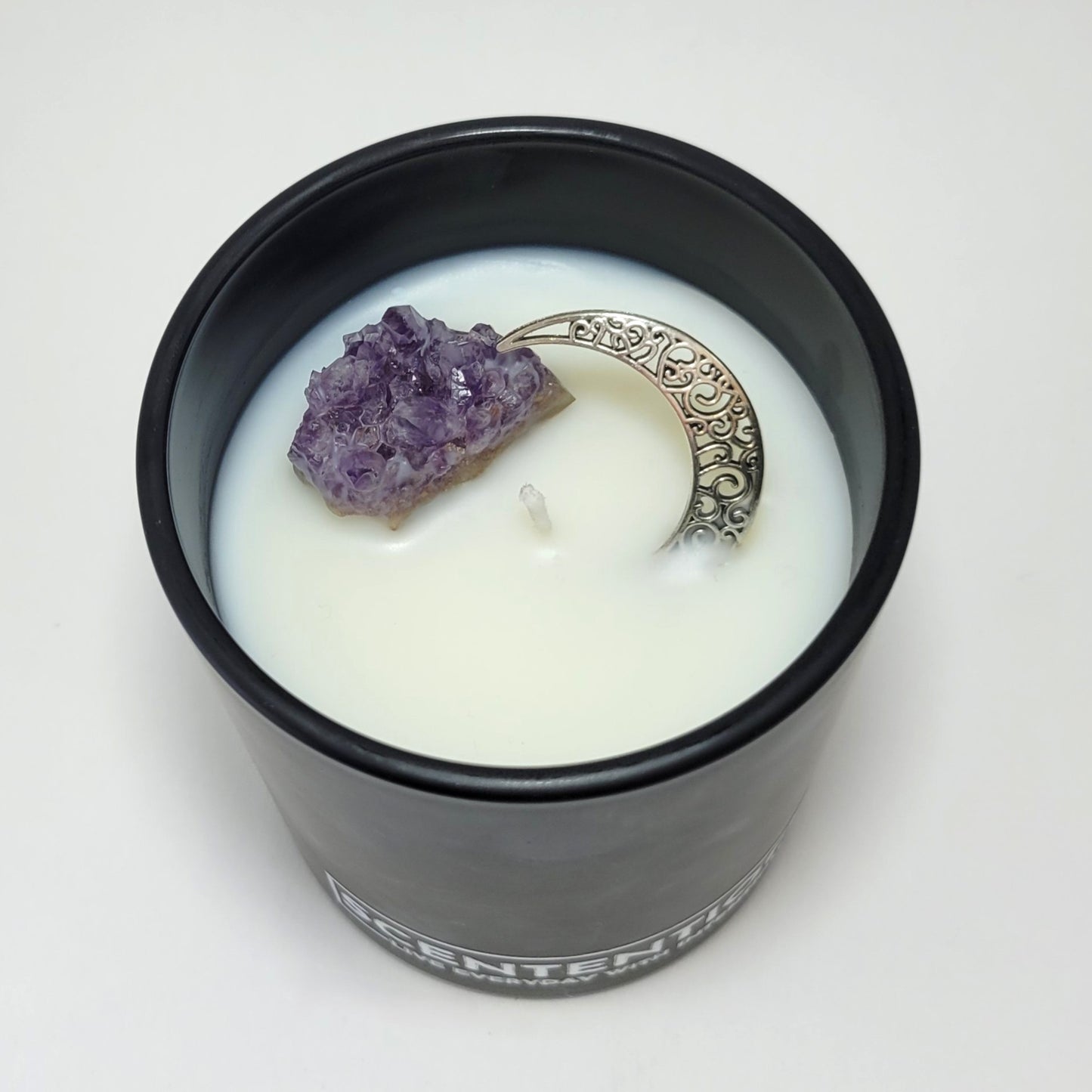 Moon + Bloom Moon Collection crystal coconut wax candle top view showing raw amethyst and silver moon charm in coconut wax.