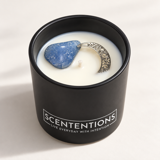 SCENTENTIONS Moon + Tide 7 oz coconut wax candle in black vessel with blue quartz crystal and silver crescent moon charm.