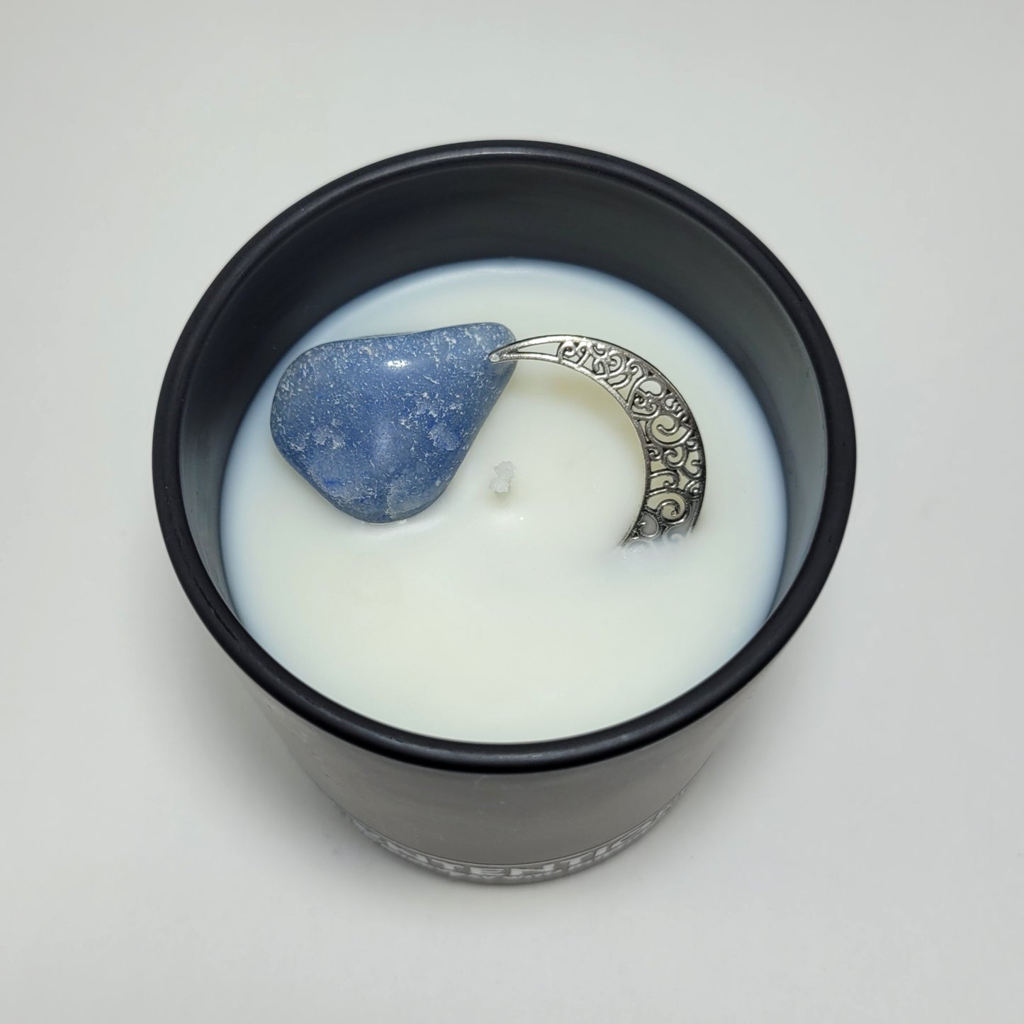 Moon + Tide Moon Collection crystal coconut wax candle top view showing clear quartz and silver moon charm in coconut wax.