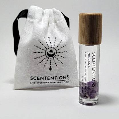 Crystal infused roll-on essential oil with Amethyst crystals next to Scententions canvas pouch