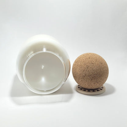 Top view of signature coconut wax candle in clear glass vessel.