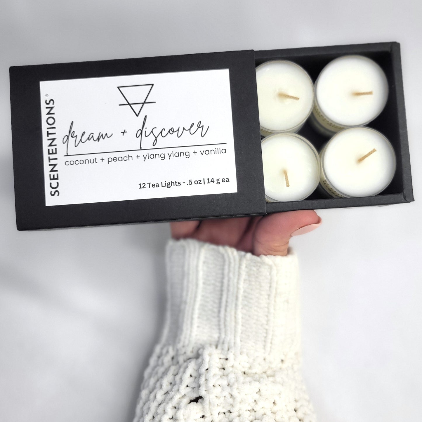 Tea Light Set open gift box held in hand showing organic coconut wax tea lights.