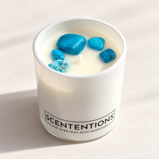 SCENTENTIONS Voyage + Vibes 7 oz coconut wax candle in white glass vessel with blue turquoise stones.