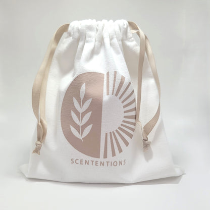 Reusable canvas drawstring tote included with Scententions Wanderlust crystal coconut wax candle.
