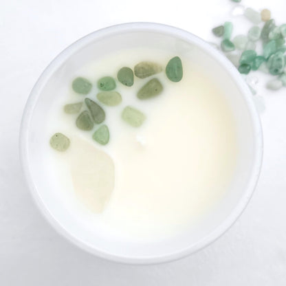 Top view of Explore + Expand candle showing embedded Clear Quartz and Green Aventurine crystals in clean-burning organic coconut wax