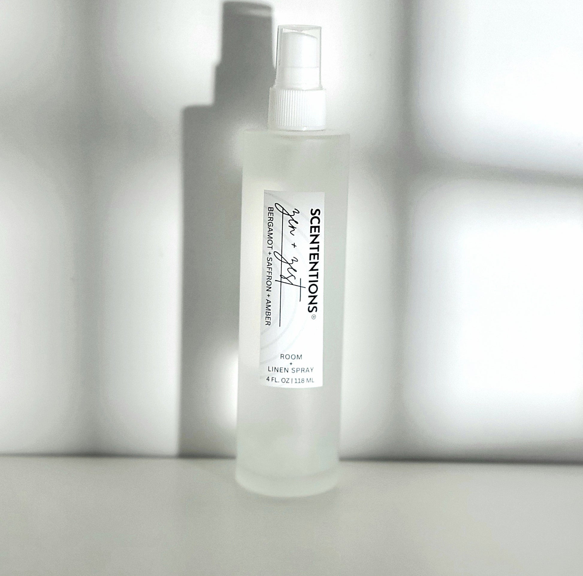 Zen + Zest room spray with notes of bergamot, saffron, and amber for calm and clarity in modern setting